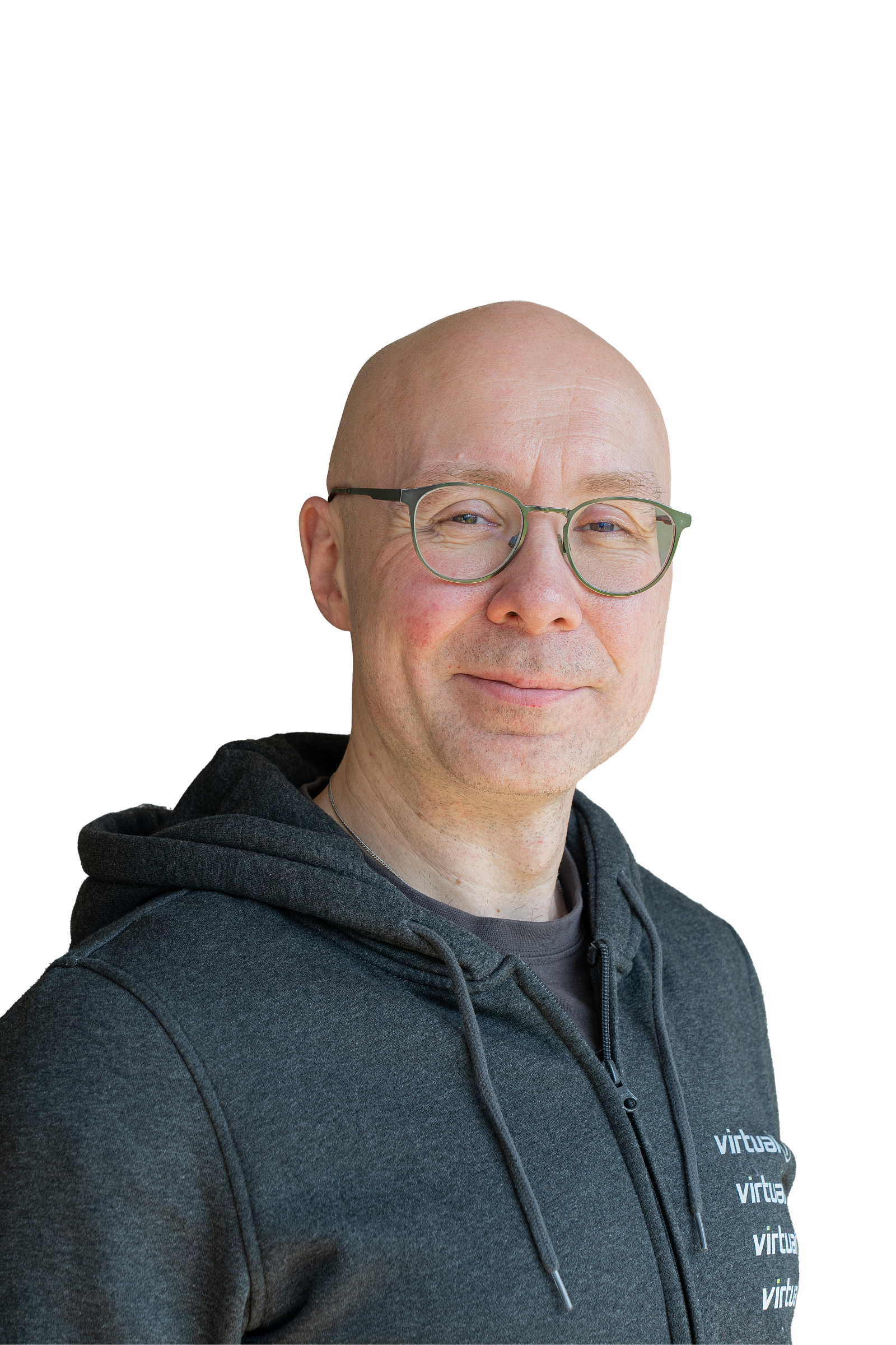 Portrait of Philipp wearing a dark gray virtual7 hoodie against a light background, wearing glasses and looking friendly.